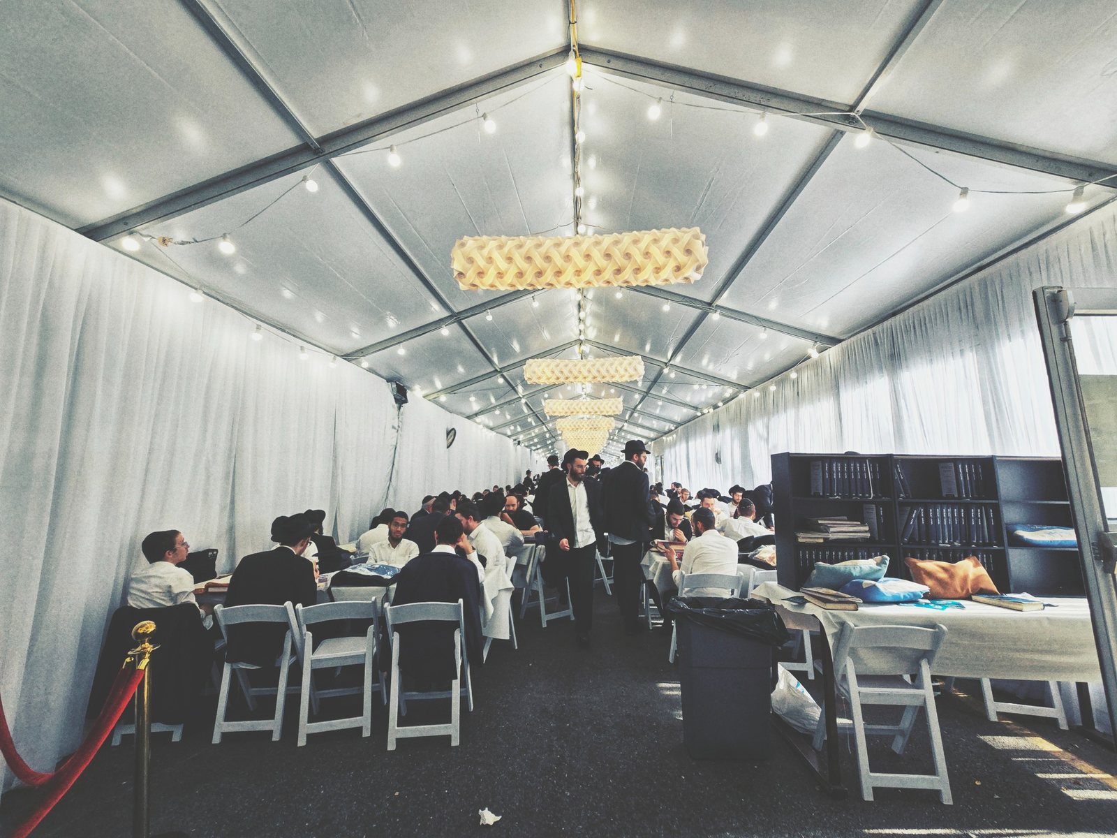Tables filled with guests learning in the Tent